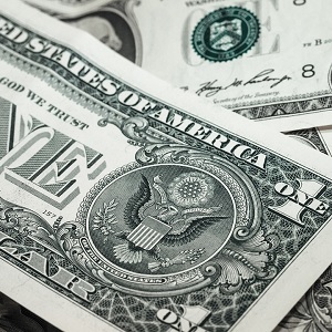 Image contains one dollar bills in a pile.